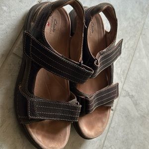 A fairly used Clark sandal in color brown, US size 11.